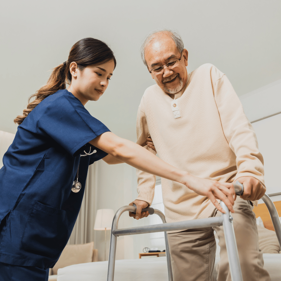 Healthcare professional assisting elderly man utilizing a walker.