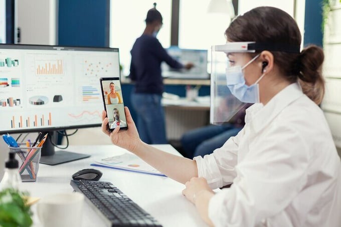 businesswoman-using-wireless-headphones-online-conference-smartphone-wearing-face-mask-workplace-multiethnic-coworkers-working-respecting-social-distance-business-global-pandem_482257-9903 businesswoman-using-wireless-headphones-online-conference-smartphone-wearing-face-mask-workplace-multiethnic-coworkers-working-respecting-social-distance-business-global-pandem_482257-9903