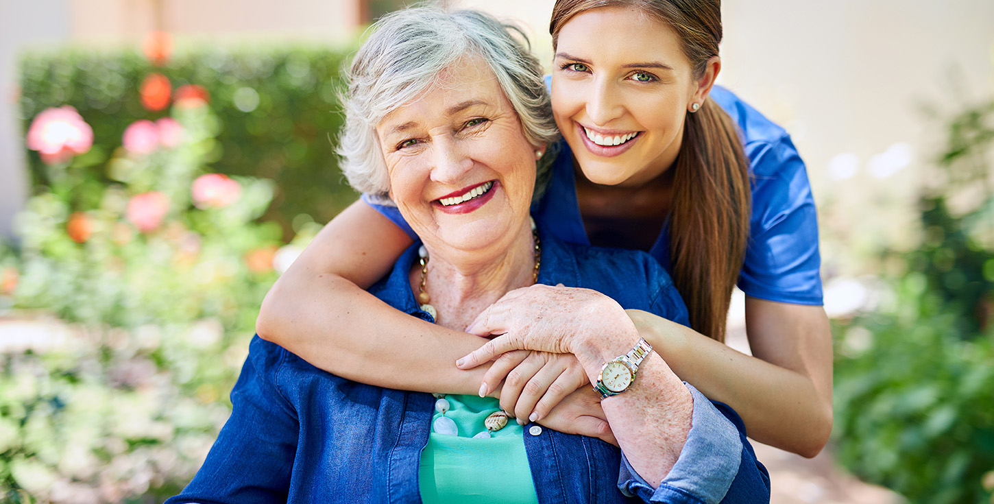 resident and a nurse outside in the retirement home