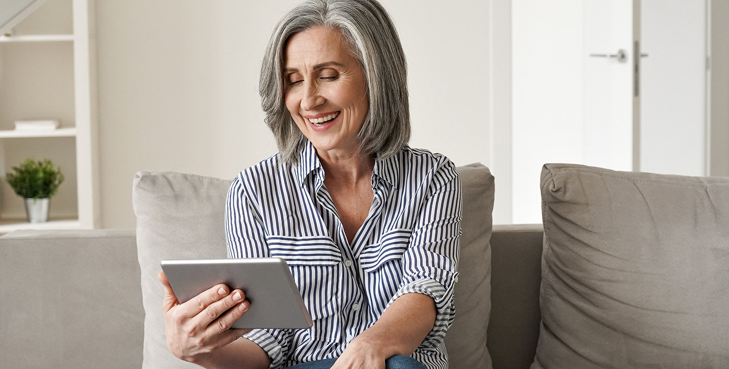 senior woman enjoying a video on her tablet