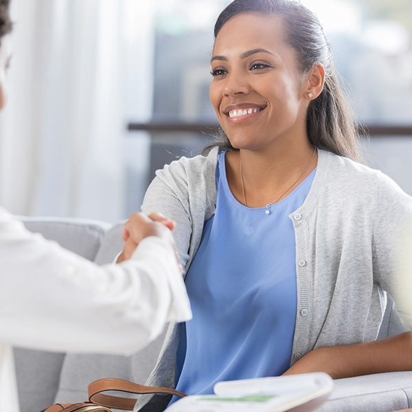 smiling black female nurse handshake