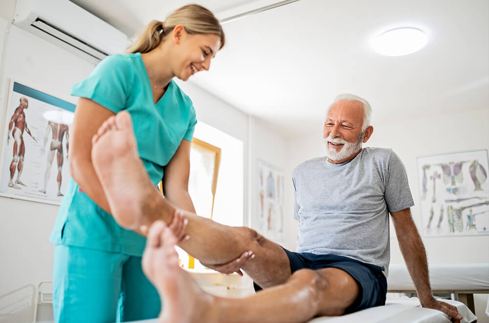 young-smiling-physiatrist-working-with-a-senior-male-patient-v01